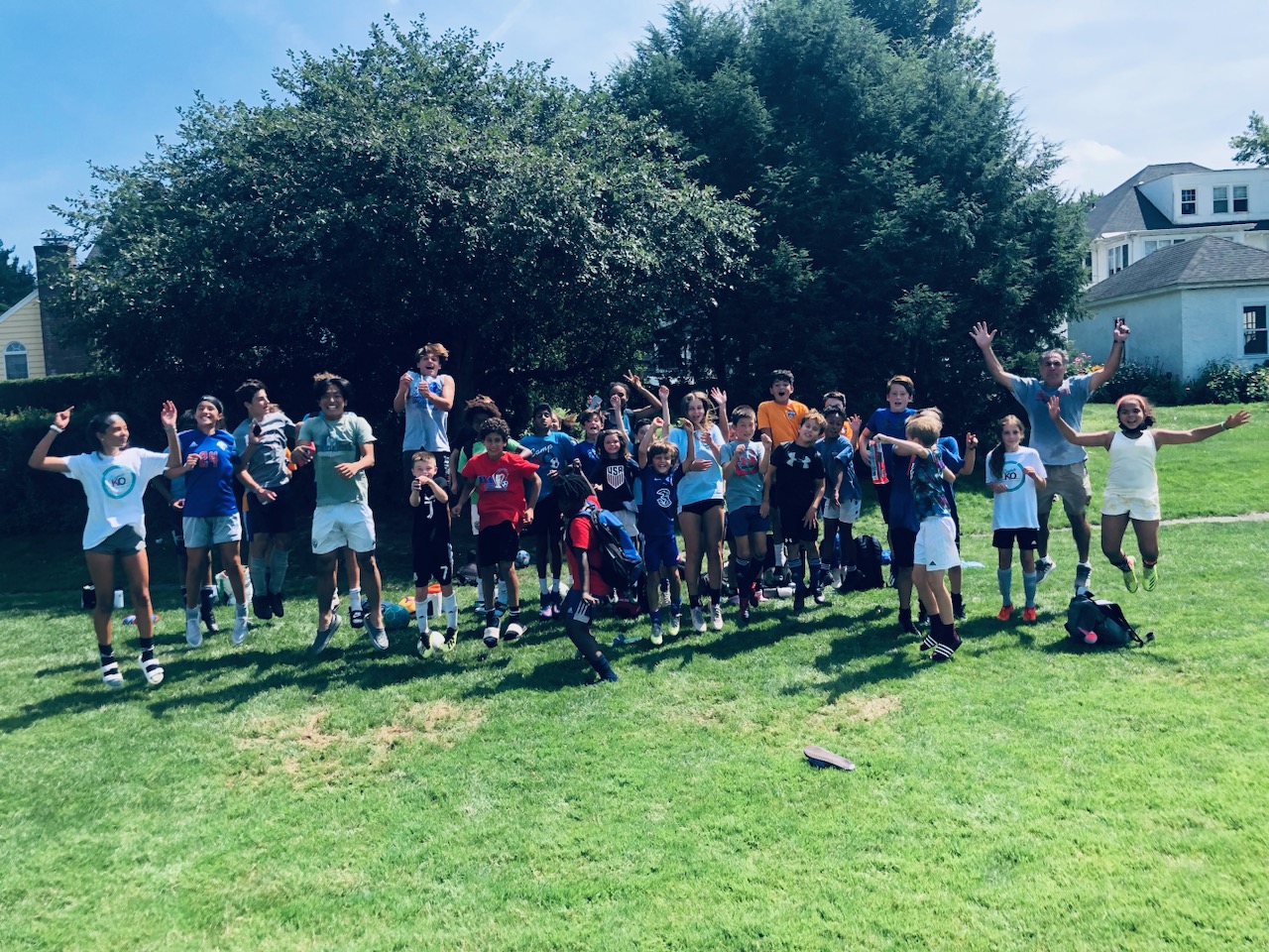 Young soccer players celebrating together at Coach Hikmet’s training program